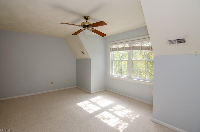 additional living space featuring lofted ceiling, light carpet, and ceiling fan