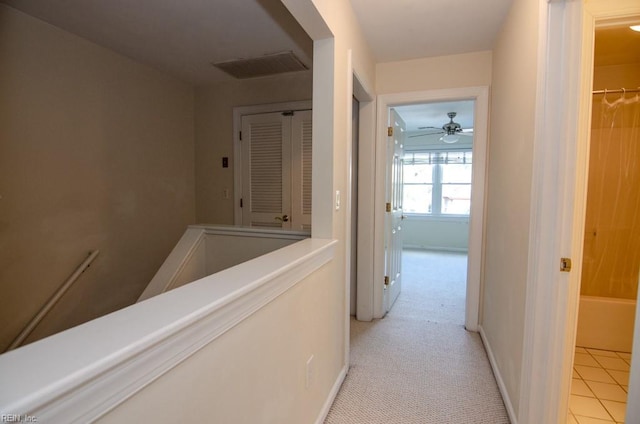 corridor featuring light tile patterned floors