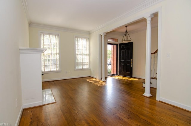 foyer entrance featuring ornamental molding, dark hardwood / wood-style floors, and decorative columns