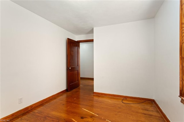 empty room with hardwood / wood-style floors