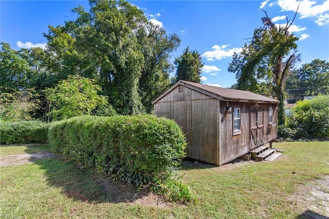 view of outbuilding featuring a yard