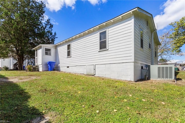 view of side of home with a yard