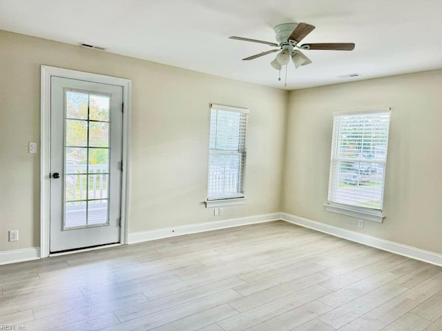 empty room with ceiling fan and light wood-type flooring