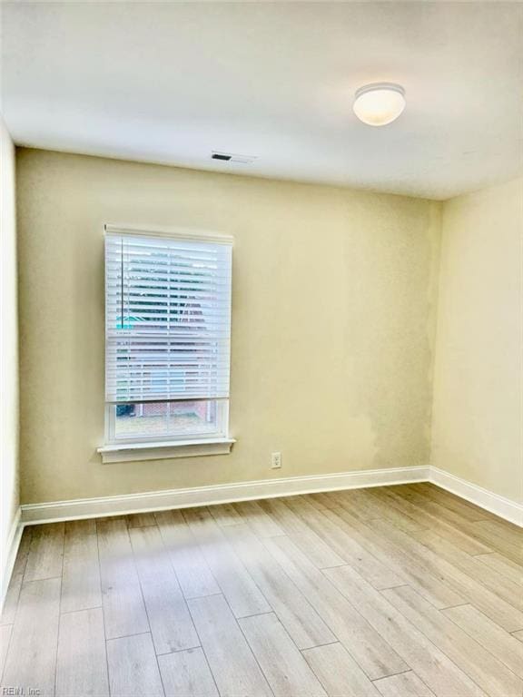 empty room with light hardwood / wood-style floors