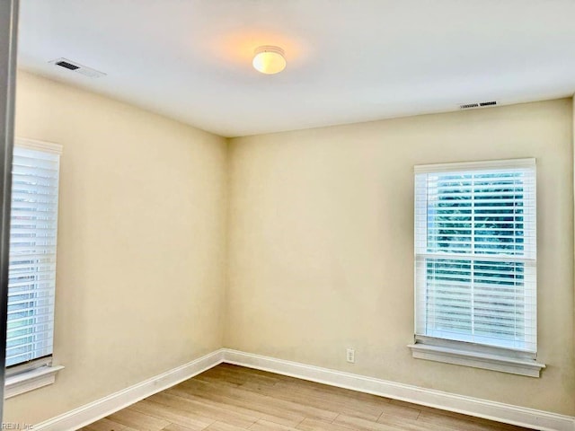 spare room with hardwood / wood-style floors