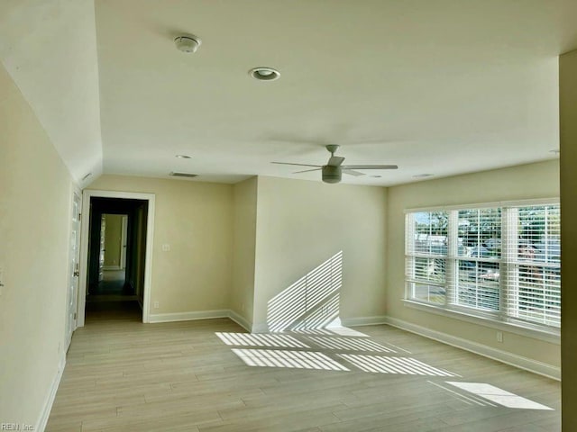 spare room with light hardwood / wood-style floors and ceiling fan