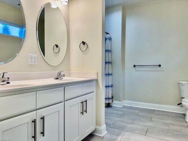 bathroom with vanity, hardwood / wood-style flooring, and toilet