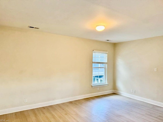 spare room featuring light wood-type flooring