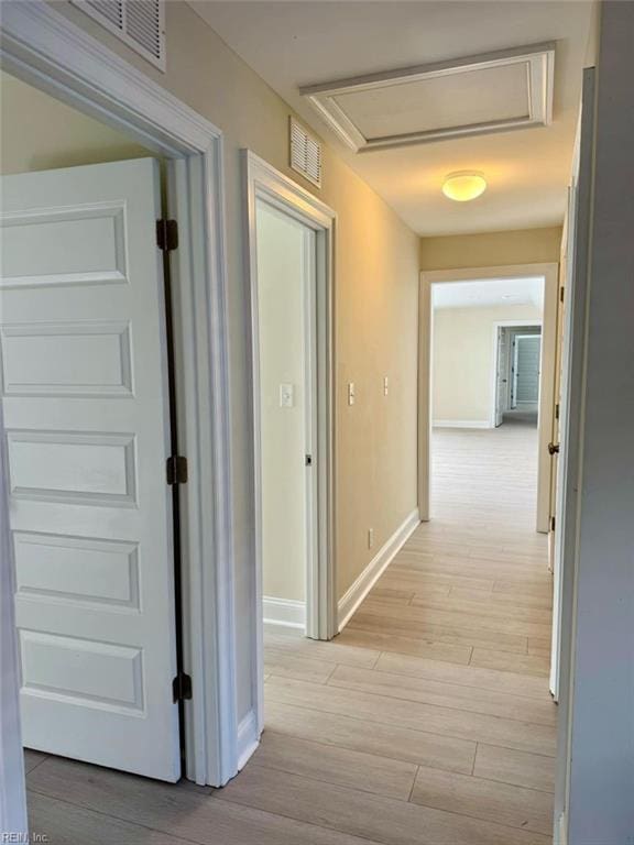 hallway with light hardwood / wood-style floors