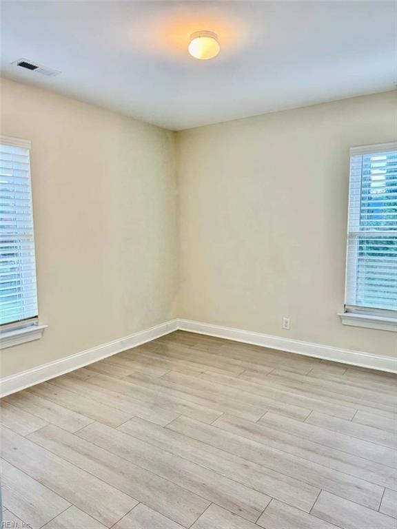 unfurnished room with light hardwood / wood-style floors