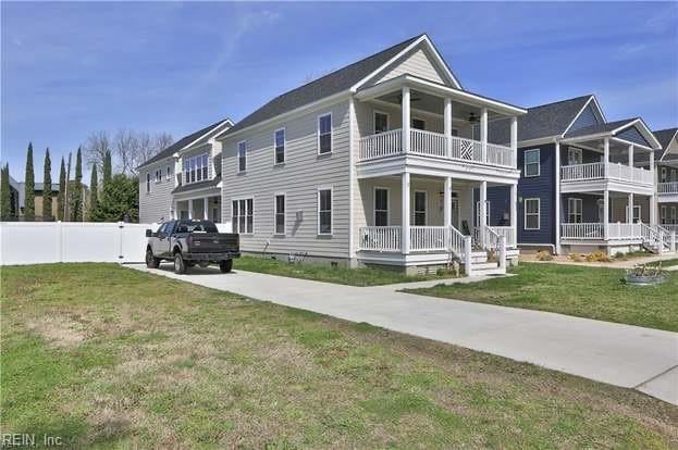 view of front of home with a balcony, a front yard, and a porch