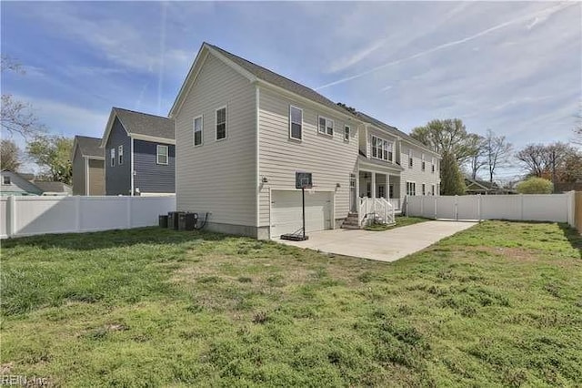 rear view of house featuring a patio and a lawn