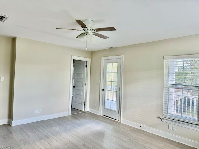 empty room featuring light hardwood / wood-style floors, a healthy amount of sunlight, and ceiling fan