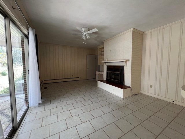 unfurnished living room with light tile patterned flooring, a baseboard heating unit, a large fireplace, ceiling fan, and wooden walls