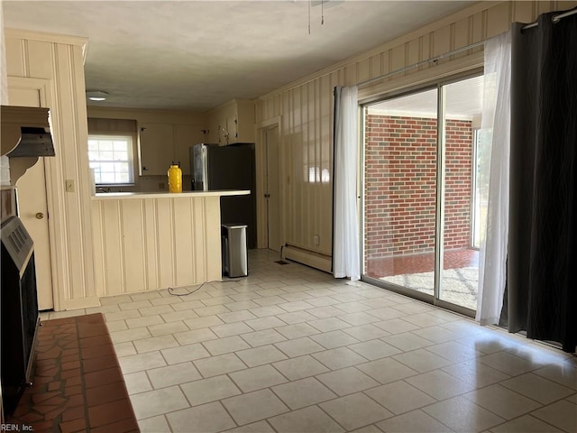 kitchen featuring ornamental molding and a baseboard heating unit