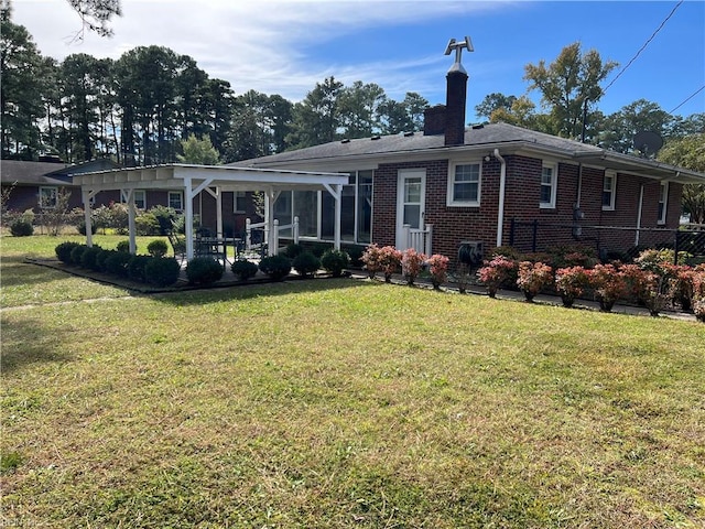 back of property featuring a yard and a sunroom