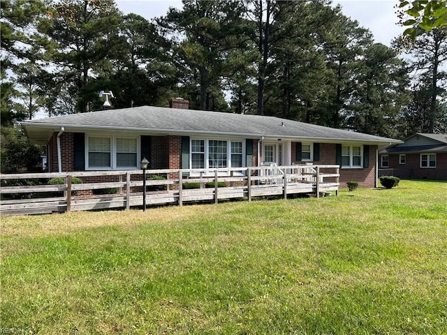 ranch-style house with a wooden deck and a front lawn