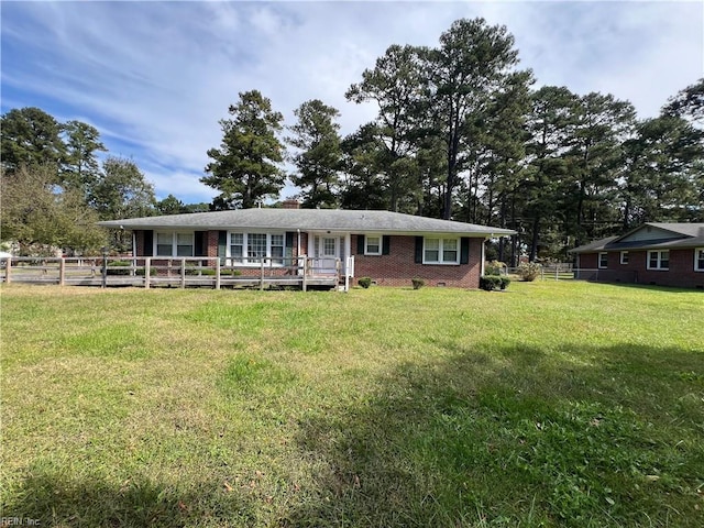 view of front of property featuring a front yard and a deck