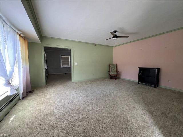 unfurnished living room featuring light carpet, crown molding, baseboard heating, and ceiling fan