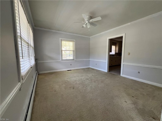 unfurnished room featuring crown molding, baseboard heating, and carpet