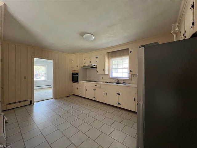 kitchen with baseboard heating, black appliances, and plenty of natural light