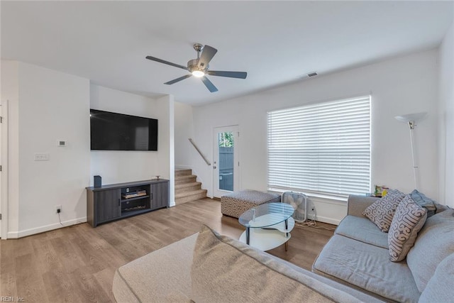 living room with ceiling fan and light hardwood / wood-style flooring