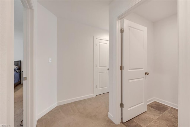 hallway with light colored carpet