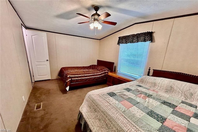 bedroom with carpet flooring, vaulted ceiling, a textured ceiling, and ceiling fan