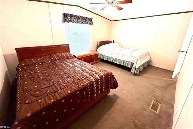 carpeted bedroom featuring ceiling fan and vaulted ceiling