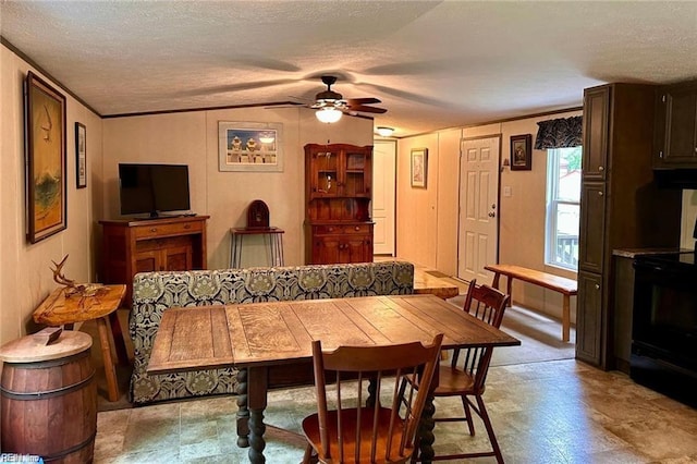 dining room with ornamental molding, a textured ceiling, and ceiling fan