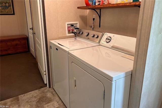 clothes washing area featuring washer and clothes dryer