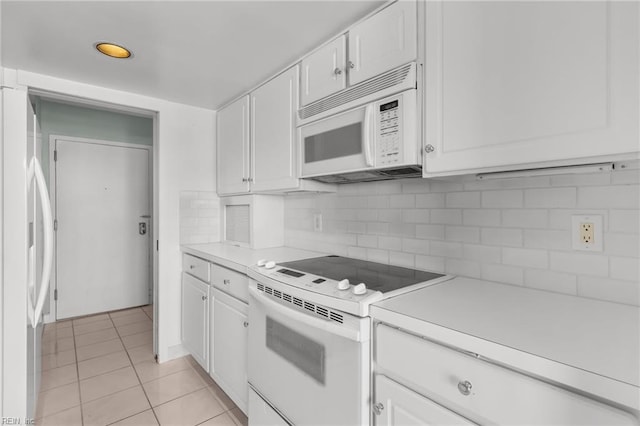 kitchen with white cabinetry, tasteful backsplash, white appliances, and light tile patterned flooring