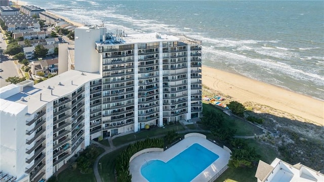 birds eye view of property featuring a water view and a beach view