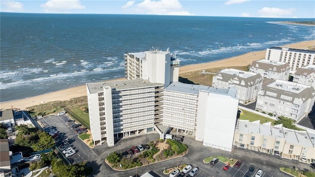 bird's eye view featuring a water view and a beach view