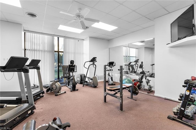 workout area featuring a paneled ceiling and ceiling fan