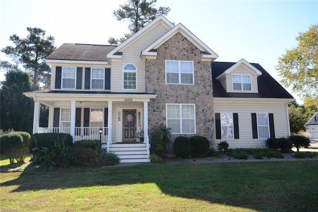 view of front of house with a front yard and a porch