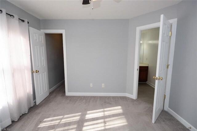 unfurnished bedroom featuring ceiling fan and light carpet