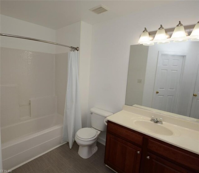 full bathroom featuring vanity, shower / bath combination with curtain, and toilet