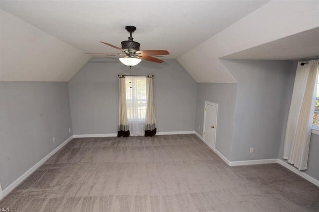 bonus room with ceiling fan, light colored carpet, vaulted ceiling, and a wealth of natural light