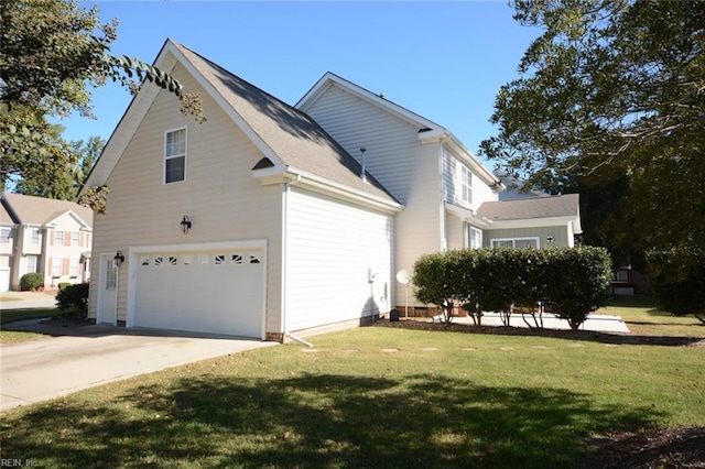 view of side of property with a yard and a garage