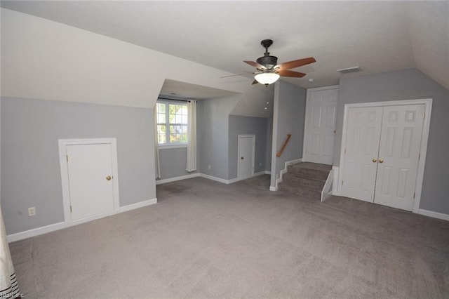 bonus room with lofted ceiling, light colored carpet, and ceiling fan