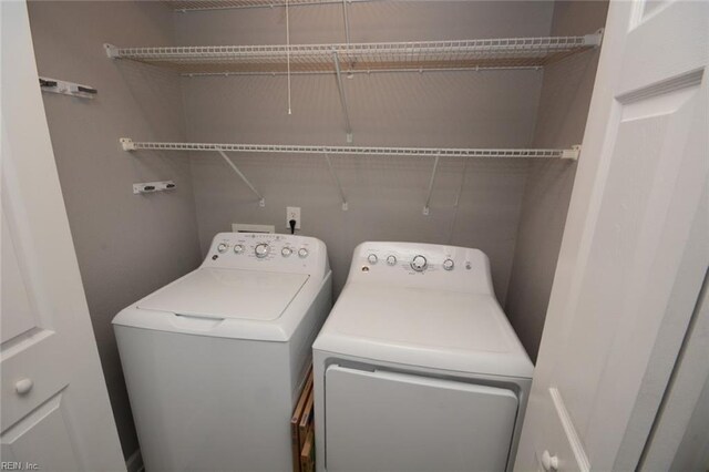 clothes washing area featuring washer and clothes dryer