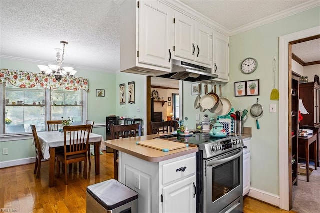 kitchen with stainless steel electric range, white cabinetry, wood-type flooring, ornamental molding, and pendant lighting