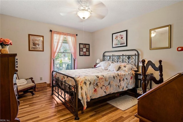 bedroom with light hardwood / wood-style floors and ceiling fan