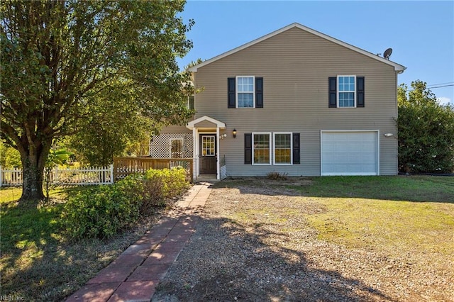 view of front of property featuring a front yard and a garage