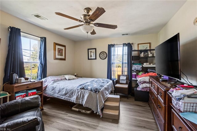 bedroom with light hardwood / wood-style floors and ceiling fan