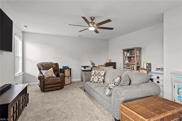 carpeted living room with ceiling fan