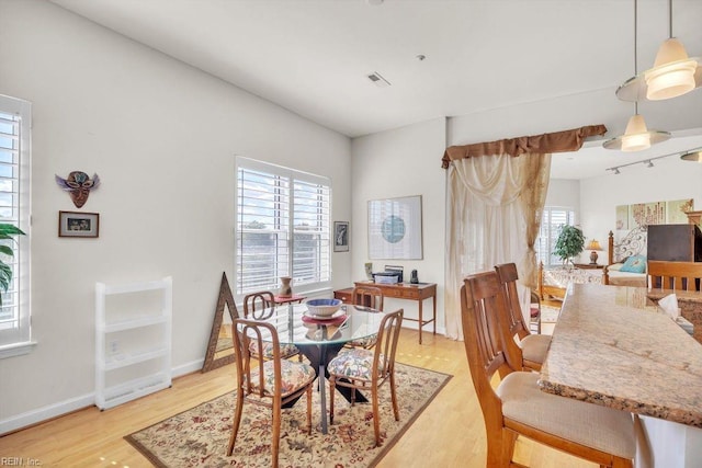 dining space with light hardwood / wood-style floors