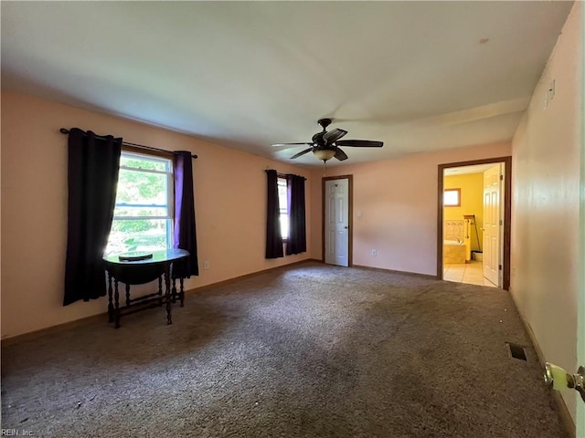 carpeted spare room featuring ceiling fan