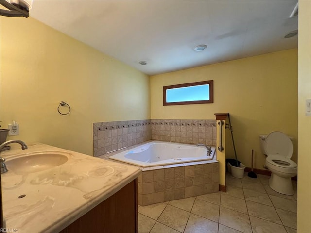 bathroom with toilet, a relaxing tiled tub, vanity, and tile patterned floors